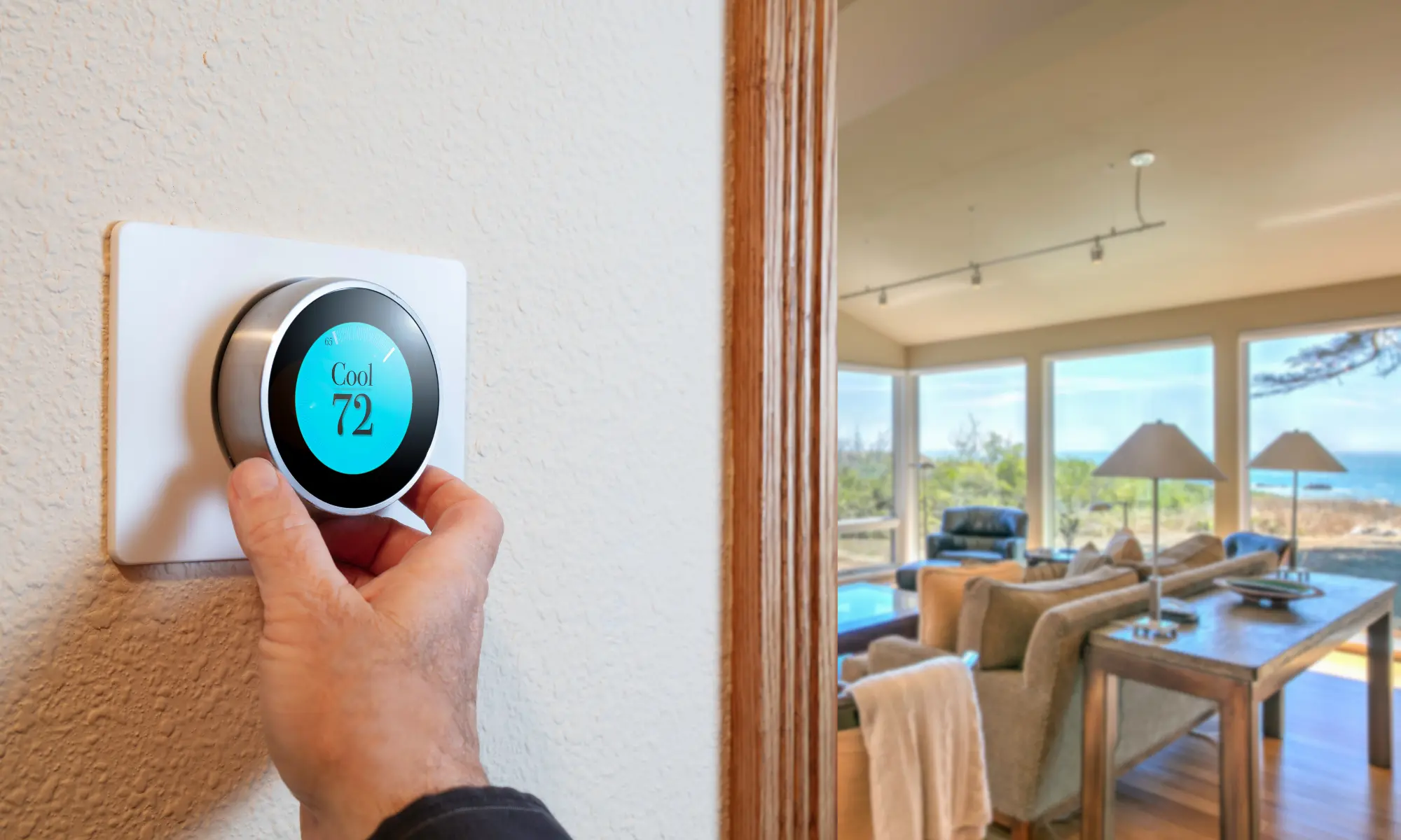 person adjusting their thermostat while having thermostat issues