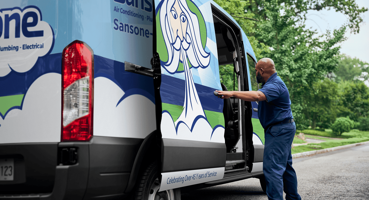 Sansone HVAC technician unloading equipment from a residential service van.