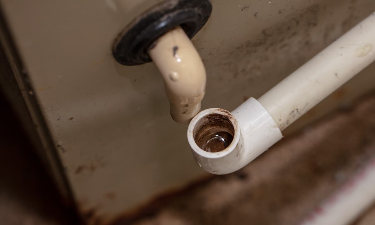AC drain line disconnected and visibly plugged.