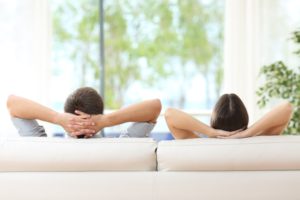 couple relaxing on couch in home with low humidity