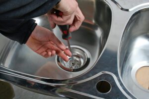 plumber repairing kitchen sink